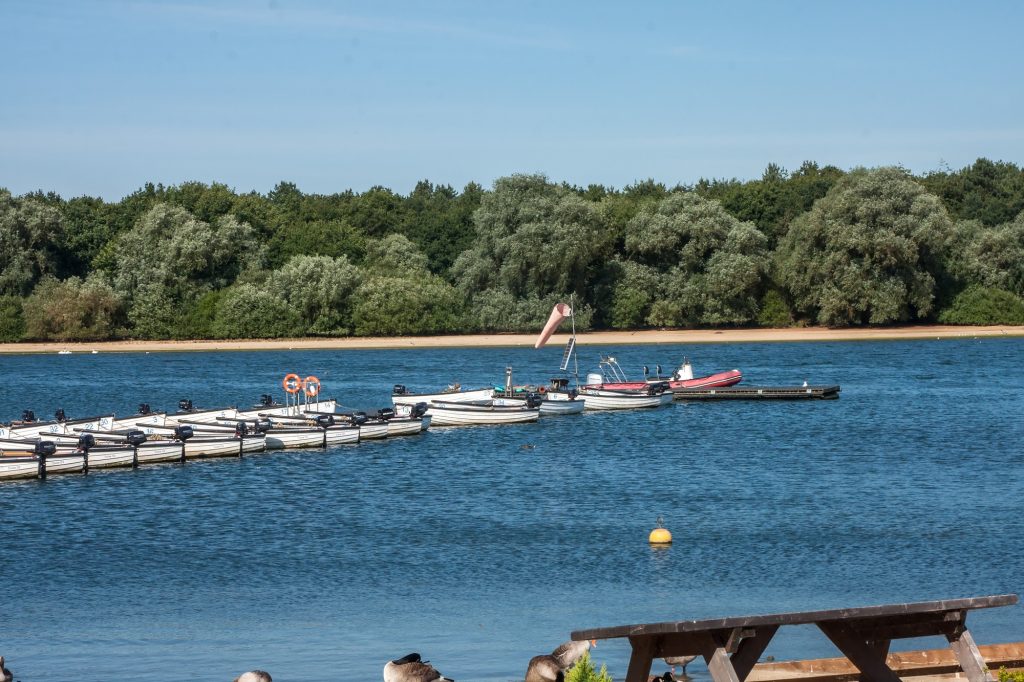 The Hanningfield Reservoir pier with speed boats docked on either side